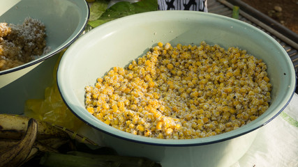 Coconut corn grain are in coconut shell a sweet dessert in the market, indonesia