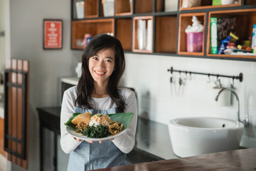 woman carrying nasi padang