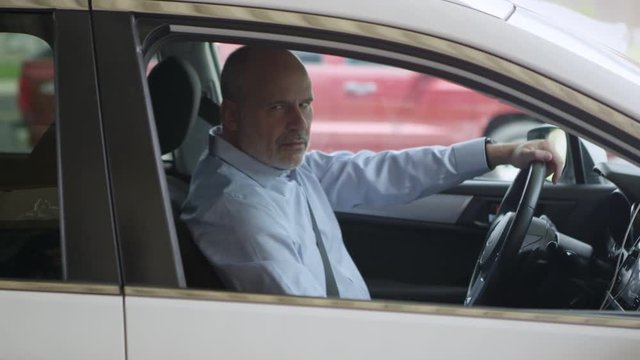 Man pulls up to taxi young woman to destination as she used Uber app to get a ride.