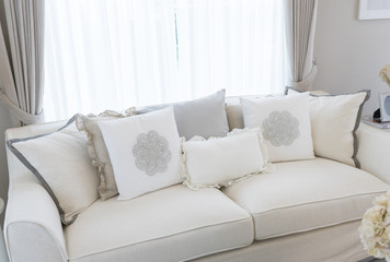 white country style sofa with many elegance cushions on it