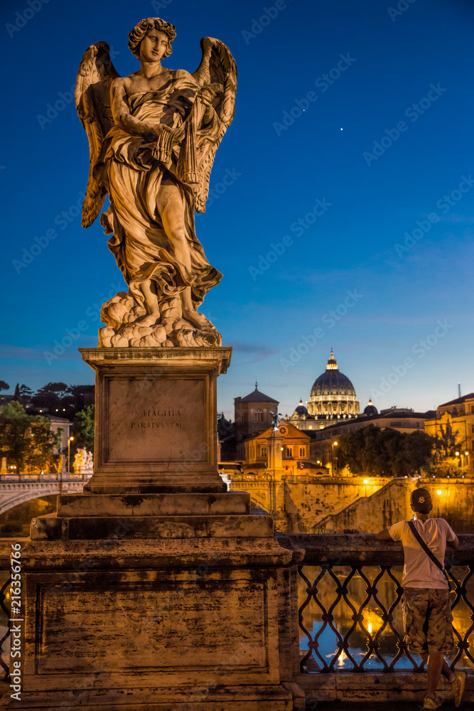 Wall mural angel with the whips by lazzaro morelli looking down at a tourist on the pont sant'angelo bridge in 