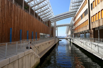 Oslo, Norway - July 24, 2018: View of Astrup Fearnley Museum of Modern Art connecting canals in waterfront of Oslo .  Contemporary art gallery in Aker Brygge district. It consists of two buildings.