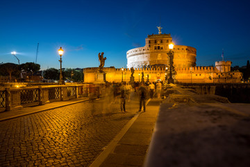 Tourists on the beautiful Pont Sant'Angelo bridge at night