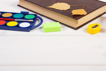 Book and school accessories on boards, back to school concept, place for text