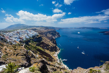 Fototapeta na wymiar Gorgeous view of Aegean sea from Fira in Santorini, Greece. Cruise ships, boats, the town of Fira the caldera can be seen in the deep blue sea.
