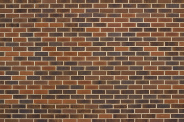 Traditional running bond brick wall background with bricks in varying shades of brown