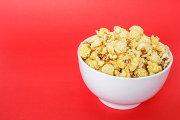 popcorn white bowl on red background