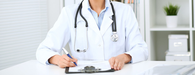 Doctor woman working at hospital.  Closeup of stethoscope. Health care, insurance and help concept