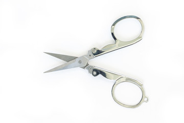 silver scissors cutting on white background