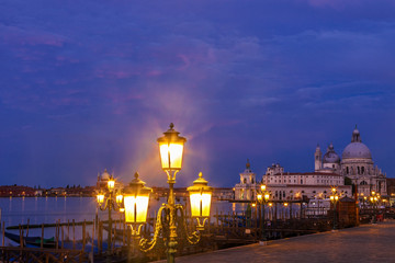 Gondolas and Venice's Santa Maria della Salute church at twilight