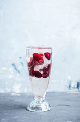 Cold cherry cocktail with ice and strong alcohol. Selective focus.