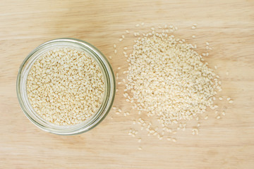 white sesame seed in jar on wood background