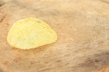 crispy potato chips junk food unhealthy food on wooden