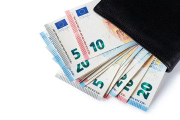 Many euro banknotes in black leather wallet, isolated on white background