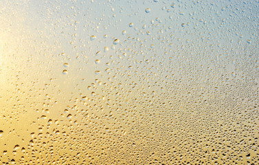 Rain drops and frozen water on window glass background