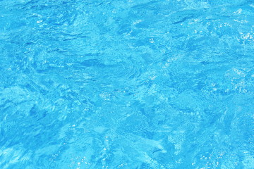 Background of clean blue rippled water in a hotel swimming pool