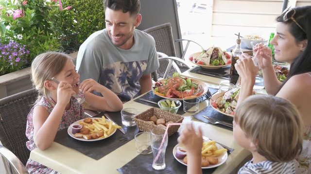 Family on vacation having lunch at hotel restaurant