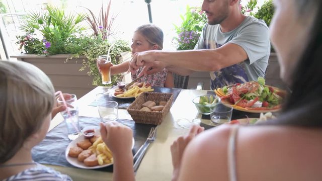 Family On Vacation Having Lunch At Hotel Restaurant