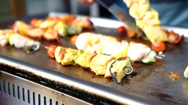 Closeup of chicken skewers cooking on grill