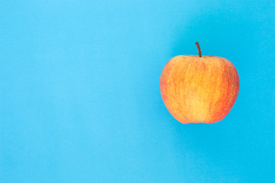 Red Apple Top Focus On Blue Background