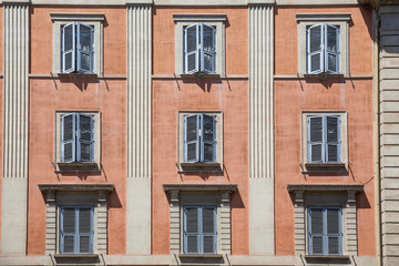 Fototapeta na wymiar Blue shuttered windows in a side street near St Peter's Cathedral, Rome, Italy