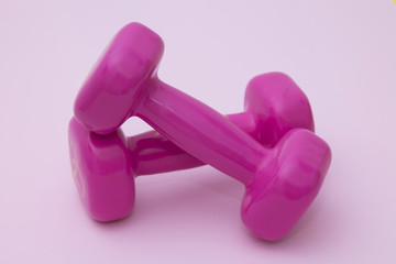 dumbbells on pink background