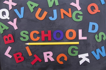 letters and pencils on blackboard, back to school concept