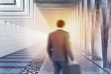 Businessman in concrete triangular pattern lobby