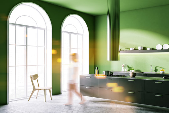 Woman in green kitchen coner