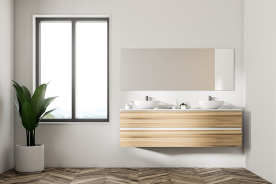 Double sink on wooden shelf, mirror and plant