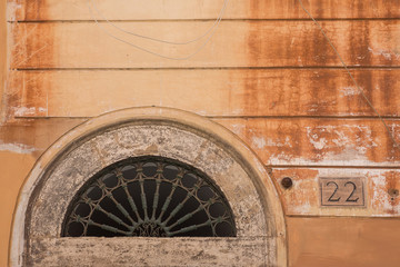 Weathered wall and door archway in Rome, Italy