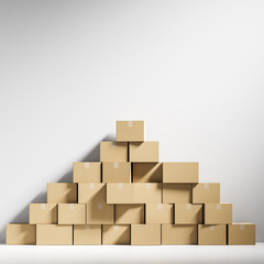 Pyramid of closed cardboard boxes in white room