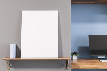 Blank poster near computer in blue room