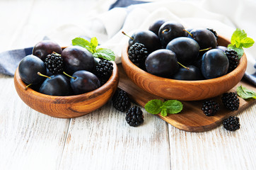 Bowls with fresh plums