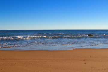 Fototapeta na wymiar Golden sand beach, blue ocean and sky background - Port Denison, Western Australia