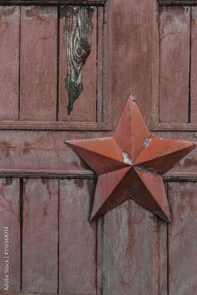 Wall mural five-pointed star on the wooden gate