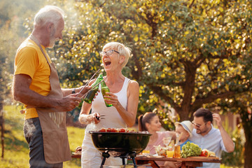 Family grilling meat on a barbecue