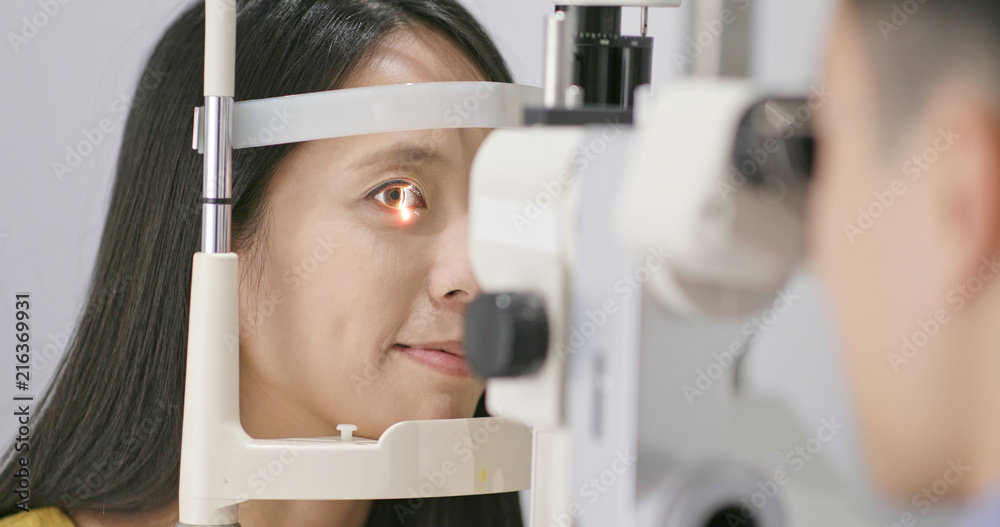 Poster woman checking on eye in clinic