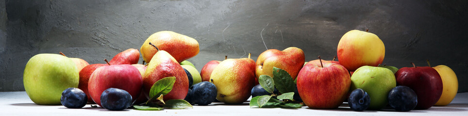 Various fresh fruits. Thanksgiving apples, and pears on rustic background.