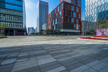 empty pavement and modern buildings in city.