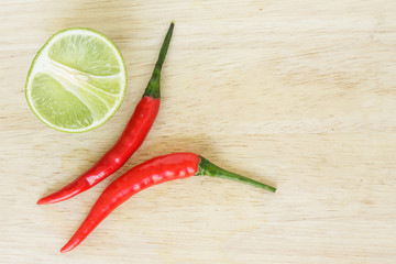 chili pepper red spicy and lime vegetable on wood background