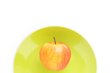 red apple on green plate top focus on white background