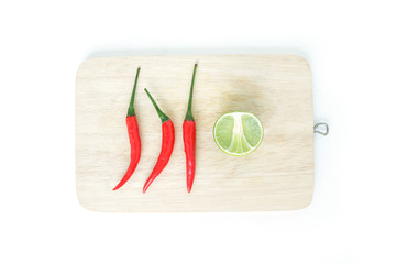 chili pepper red spicy lime vegetable cutting board on wood background