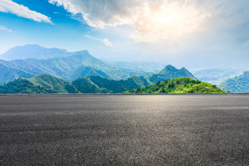 Asphalt road and beautiful mountain scenery under the blue sky