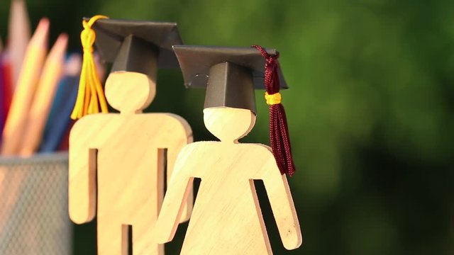 Back to School Concept, Two People Sign wood with Graduation celebrating cap on open textbook show alternative studying. Graduate or Education knowledge learning study abroad international Ideas.