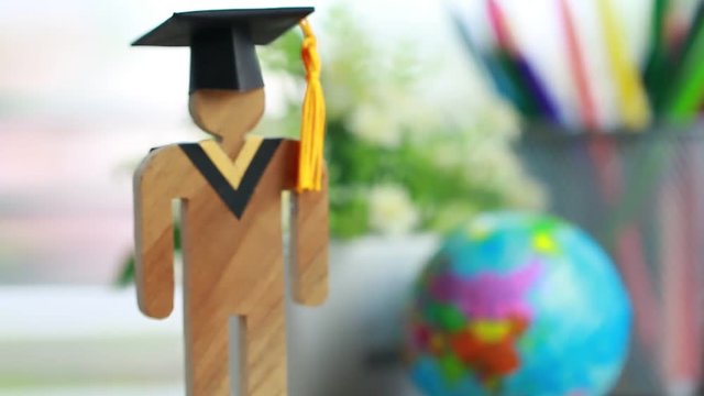 Education knowledge learning study abroad international Ideas. People Sign wood with Graduation celebrating cap on open textbook, America global map show alternative studying Back to School Concept