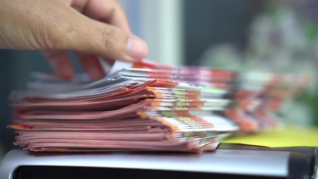 Business Documents concept : Businessman hands working in Stacks Brochures paper files for checking document achieves reports on busy work desk office
