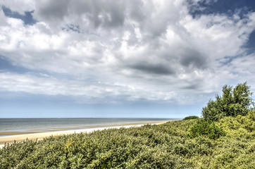 Fototapeta na wymiar Spectacular cloud formations over the Northsea beach and adjacent dunes near Rockanje, The Netherlands