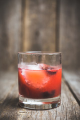 Old fashioned cocktail with cherry. Selective focus.