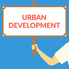 URBAN DEVELOPMENT. Hand holding wooden sign